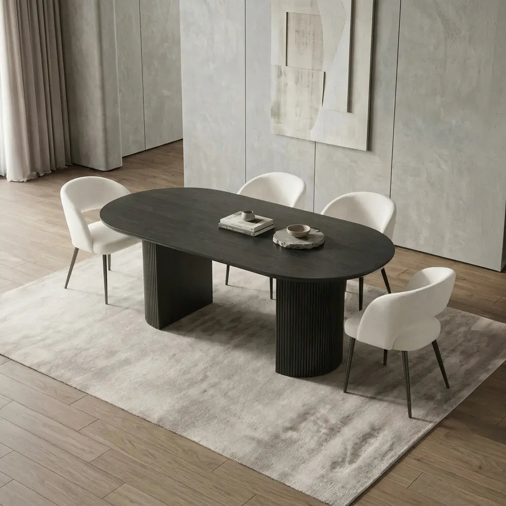 Black fluted oval dining table styled with cream upholstered dining chairs