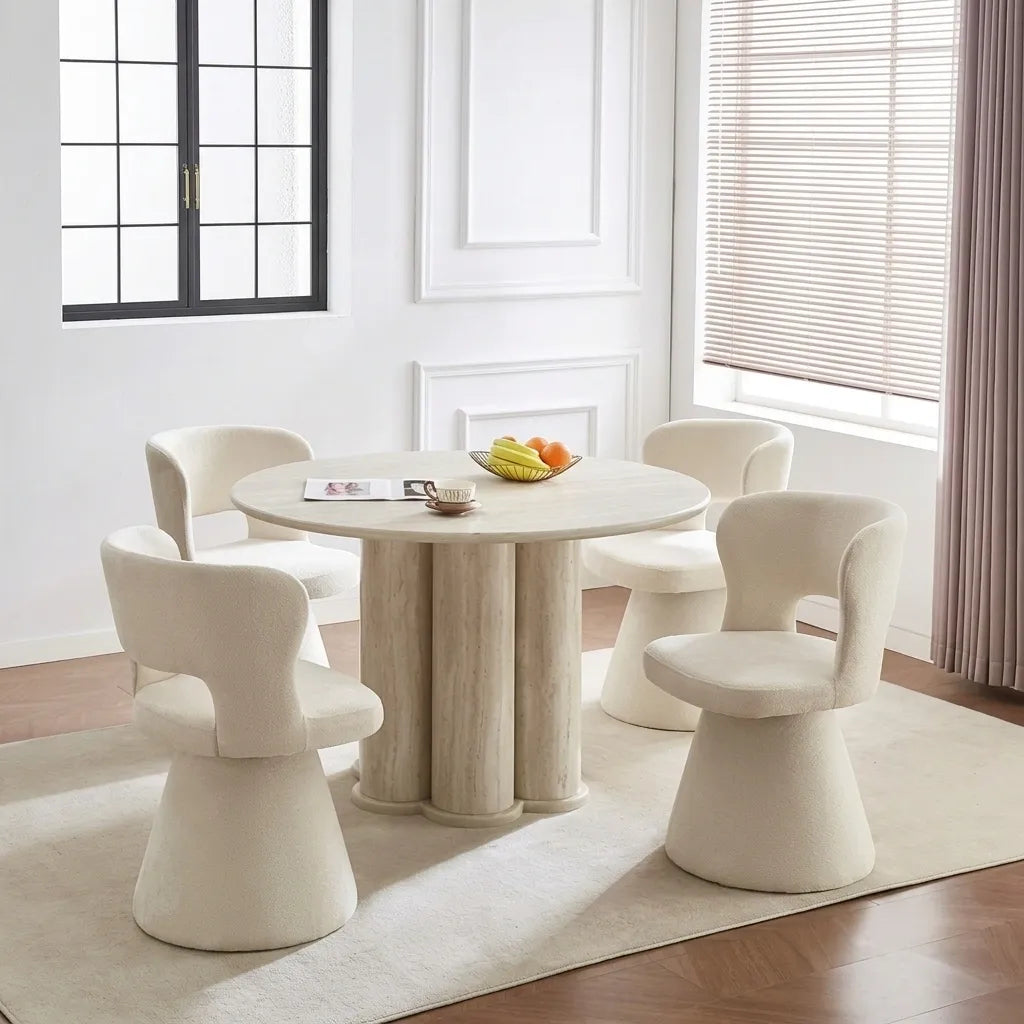 round travertine-look dining table with four cream swivel chairs