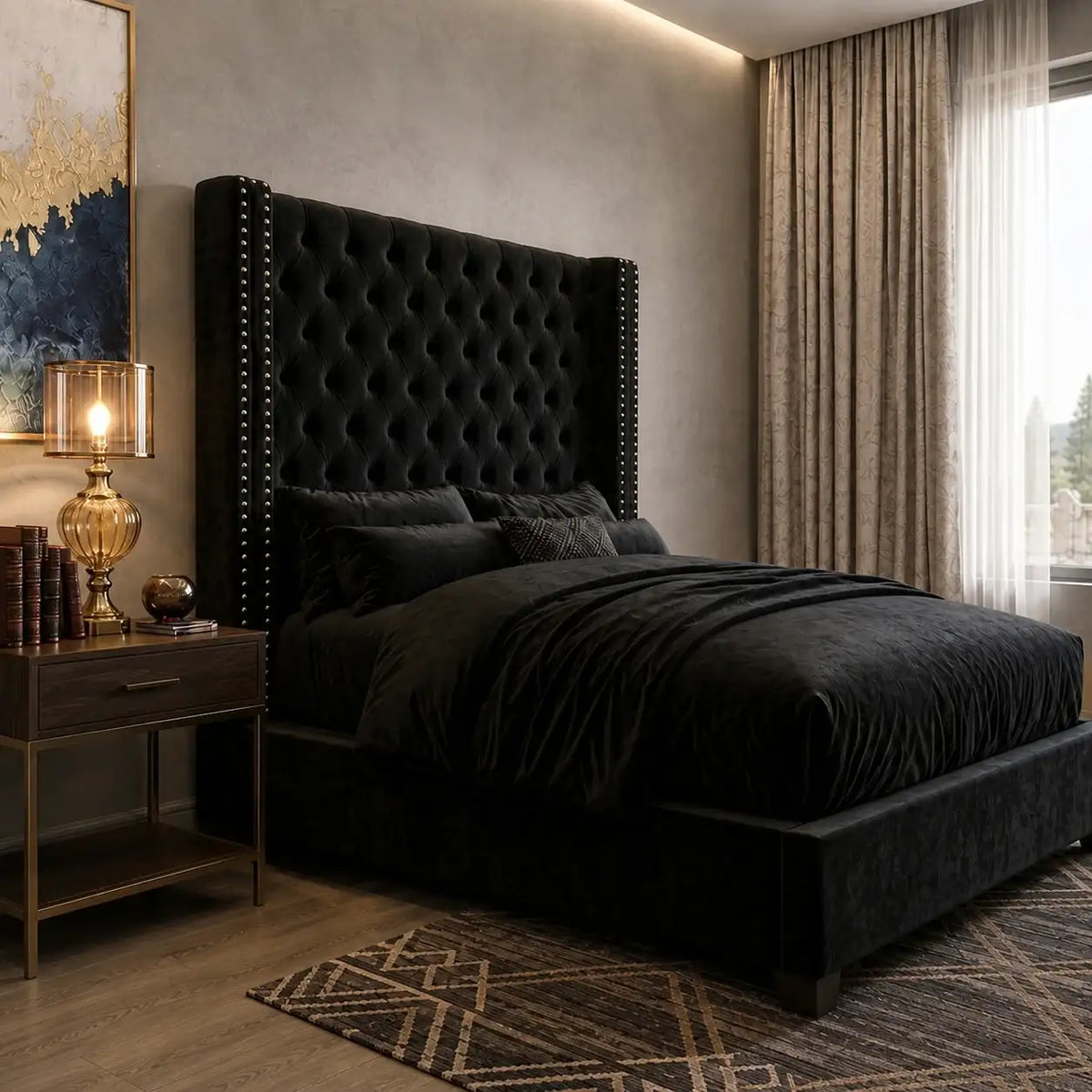 Side angle view showing the profile and silver nailhead trim of black velvet tufted wingback bed