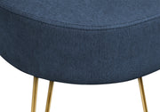 close up blue fabric gold legs ottoman