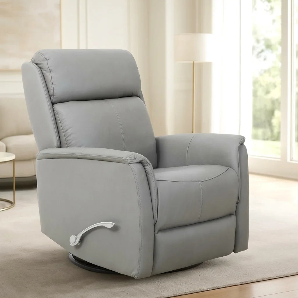 A grey padded reclining armchair, in its upright position, shown from a three-quarter perspective, angled slightly to the right. The curved silver manual-recline handle is clearly visible on the lower left side. The black circular base is visible beneath the chair on the white background.