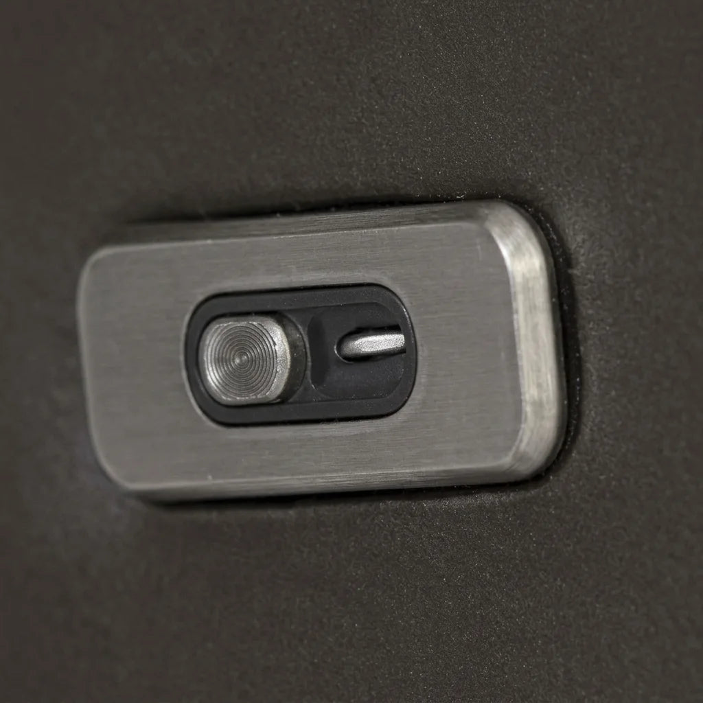 A photorealistic image of the gray fabric power recliner with the footrest partially extended, showing the control panel on the side and the metal mechanism.
