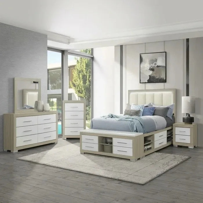 A photograph of a complete Emma Bedroom Set, including a modern light wood and white bed frame with an illuminated headboard, a mattress with bedding, a nightstand, a six-drawer dresser with a mirror, and a five-drawer chest, all on a grey rug and wood floor in a brightly lit room