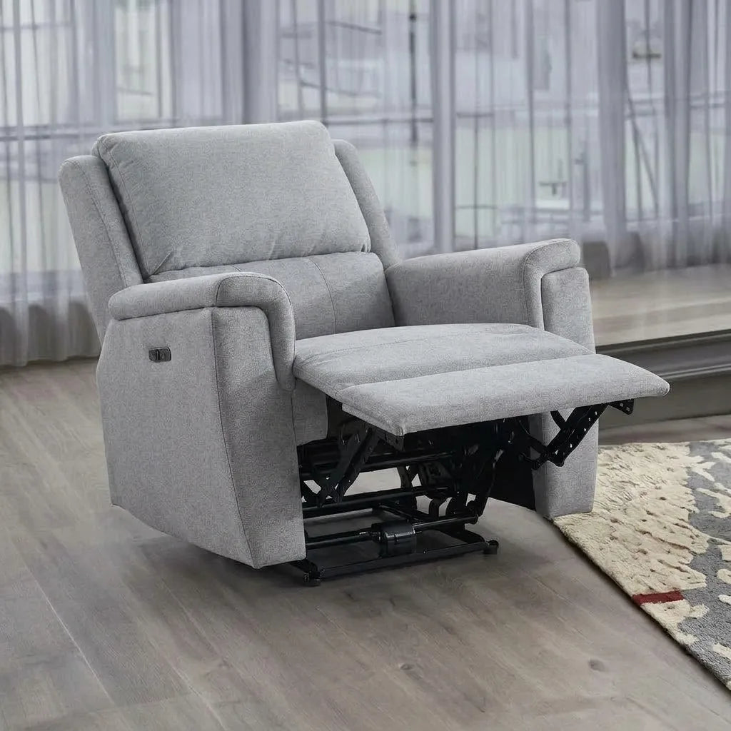 Square aspect ratio image of a light grey fabric power reclining armchair in a living room