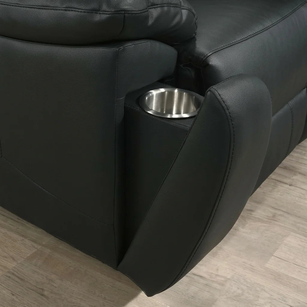 Close up detail of the stainless steel metal cup holder in the armrest of a black leather theater recliner.