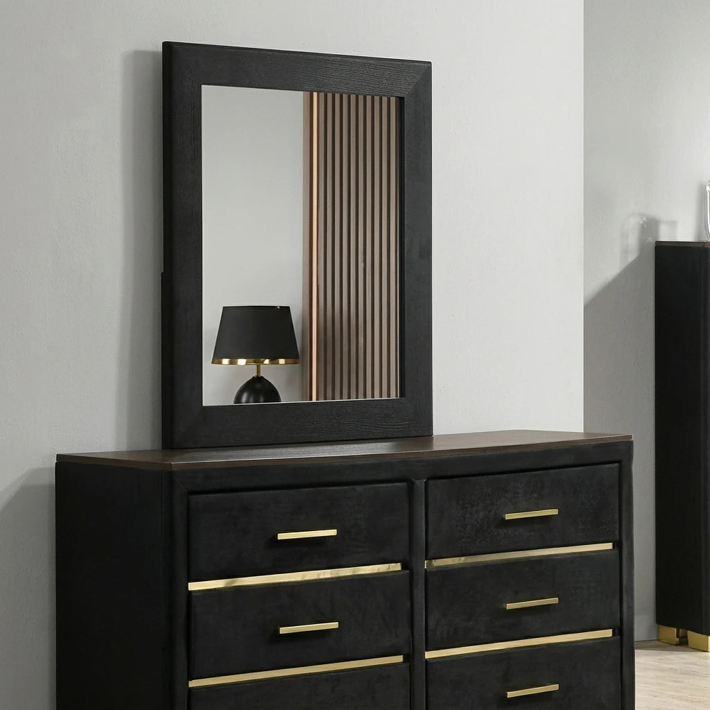 Angled shot of the Madison black velvet dresser and rectangular mirror showing gold hardware details and wood accent top